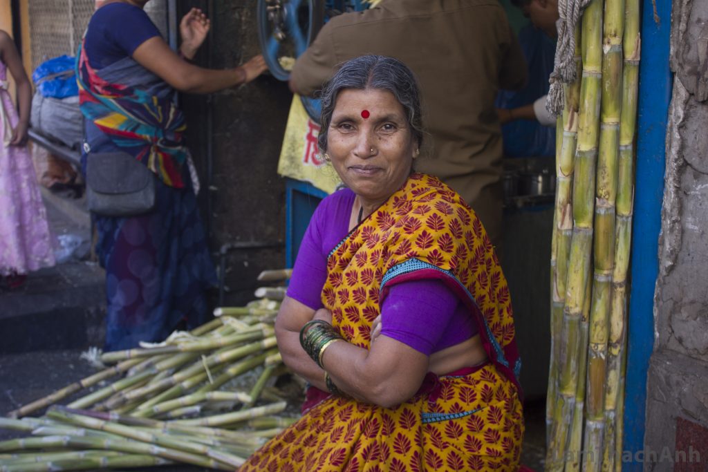 The woman selling sugarcane next door told us that she wanted a picture. And she looked directly to the camera with that smile