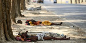 Indian homeless men rest under trees on a hot summer day in Allahabad on May 13, 2015. AFP PHOTO/ SANJAY KANOJIA (Photo credit should read Sanjay Kanojia/AFP/Getty Images)